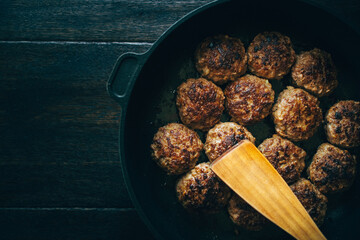 close up of meatballs in pan