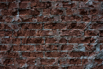 the wall is made of old red brick