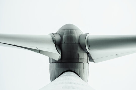 bottom view of wind turbine against sky