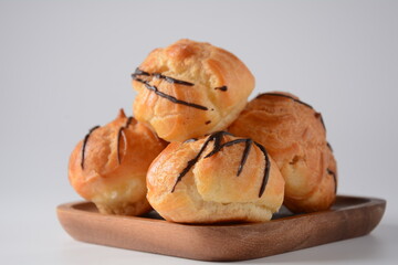 Eclair drenched in chocolate stuffed with white crème