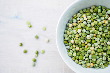 close up of white bowl with green peas