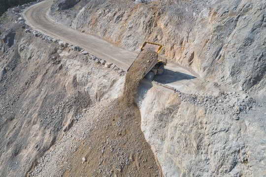 Mining truck unloading from aerial view