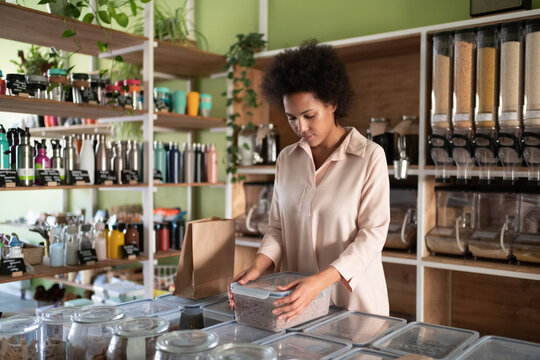 Mixed race woman working in zero waste shop