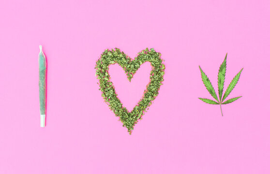 Phrase "I love Weed" made with marijuana on pink background.