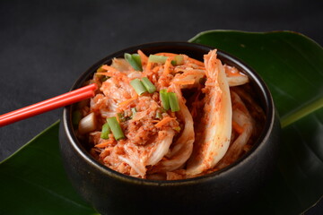 Kimchi and rice in black bowl with chopstick. Korean food