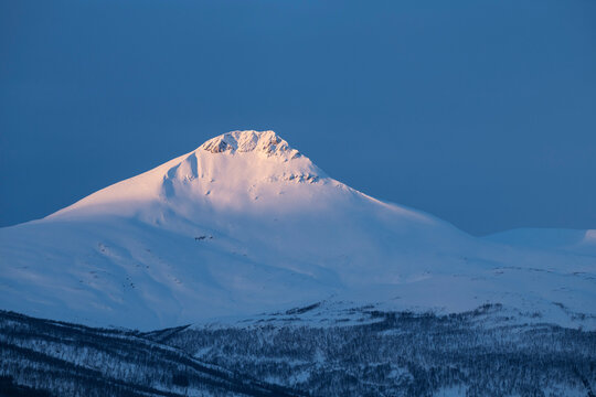 First light shines over summit of Fugltinden, Troms, Norway