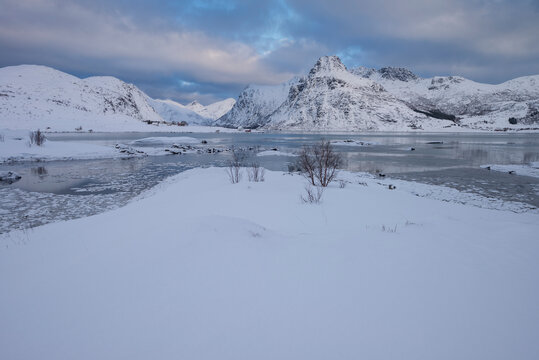 Ice filled bay with distant mountains at Flakstadpollen, Flakstad&radic;&prod;y, Lofoten Islands, Noway