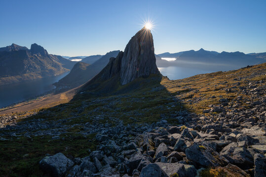 Sun shines over summit of iconic Segla mountain peak, Senja, Norway
