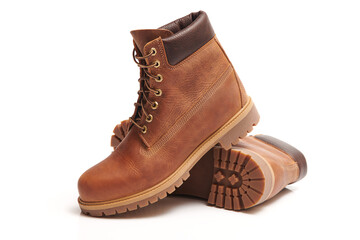 Pair of Mens leather brown waterproof boots for winter or autumn hiking isolated on white...