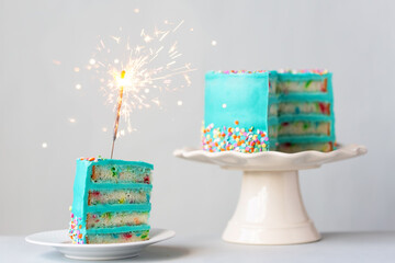 Birthday cake with colorful frosting and sparkler