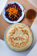 Pancakes with wild berries in  plate.Maslenitsa