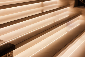 Obraz premium LED illumination of steps of a marble staircase, close up view