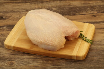 Raw whole chicken breast with skin
