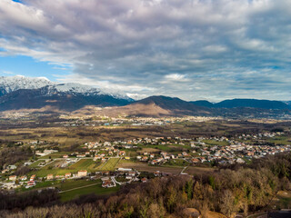 Panoramic from above on the ancient village of San Lorenzo di Buja and on the snow-capped mountains.