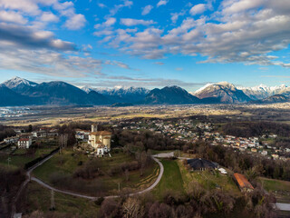 Naklejka premium Panoramic from above on the ancient village of San Lorenzo di Buja and on the snow-capped mountains.