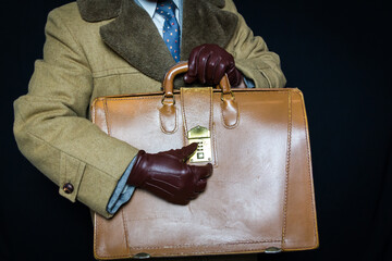 Portrait of Businessman in Suit and Fur Coat Working Combination Lock on Attache Case. Concept of...