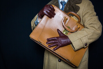 Portrait of Businessman in Suit and Brown Fur Coat Holding Attache Case Protectively. Concept of...