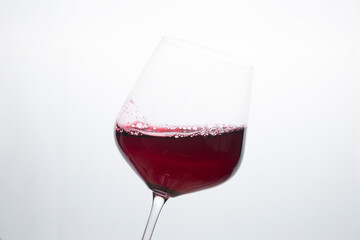 Red wine in a glass on a white background.