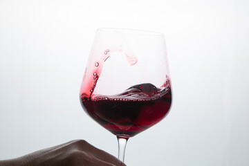 Red wine in a glass on a white background.