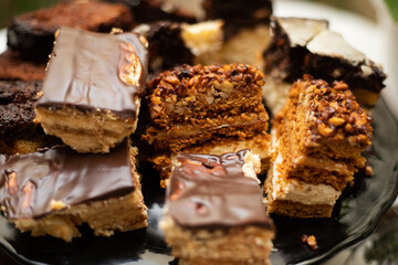 Plate full of tasty cakes with chocolate and peanuts