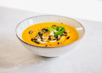 Pumpkin sweet potato lentil cream soup with pumpkin seeds