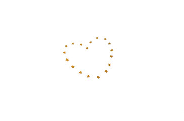 A heart made of little golden stars. Valentine's Day concept. Flat lay, top view.
