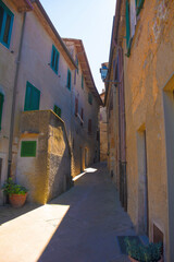 Fototapeta na wymiar A street of historic stone buildings in the village of Montorsaio in Tuscany, part of Campagnatico in Grosseto province 