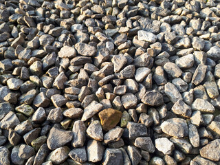 Natural stone pebble material texture background. stone background, dark gravel pebbles stone