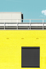 Yellow Brick Facade under Teal Blue Sky. Industrial Style. Minimal Aesthetics.