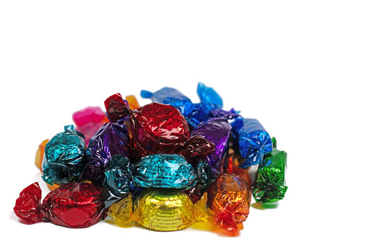 Bonbons in bunter Folie verpackt vor wei&szlig;em Hintergrund