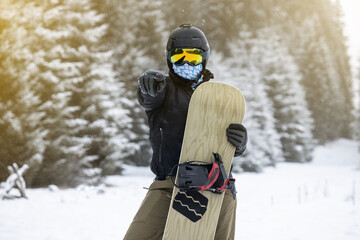 Young girl snowboarder showing something