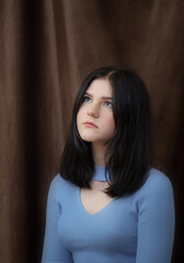 Naklejka premium beautiful brunette teenager girl on dark background