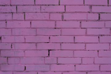 Background, texture of a pink brick wall. The bricks are arranged in rows and are painted in a delicate pink color