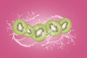 kiwi slices with water splash isolated on pink blackground.