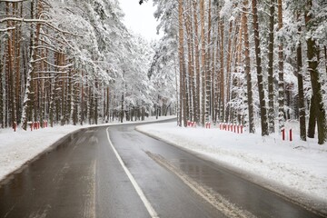 Snow covered road. Driving road through in winter forest.