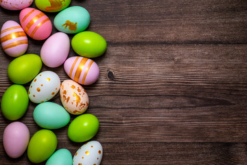 Fototapeta na wymiar Easter eggs on wooden background. Colorful Easter eggs on a wooden background of boards