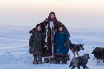 Fotobehang Yamalo-Nenets Autonomous Okrug, extreme north, Nenets family in the national winter clothes of the northern inhabitants of the tundra, the Arctic circle, mother with children © evgenii