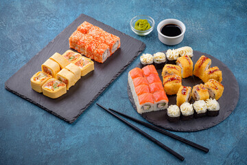 Set of sushi rolls on a blue background. Japanese oriental cuisine.