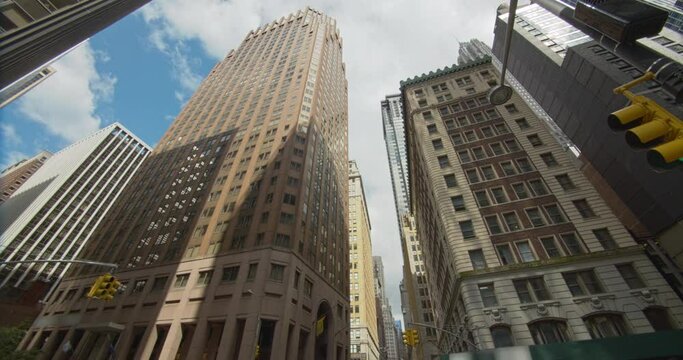 New York City cityscape, Financial District corporate buildings panning view, Wall Street signpost