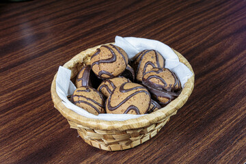 Dark chocolate butter cookies in a straw basket.