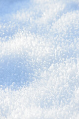 Hoarfrost background texture. Fresh ice and snow winter backdrop with snowflakes and mounds. Seasonal wallpaper. Frozen water geometrical shapes and figures. Cold weather atmospheric precipitation.