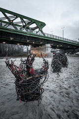 Worm made from cables as an art placed in sand in Bratislava