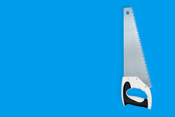 Metal hand saw with a plastic handle on a blue background.