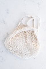 Eco cotton and net shopping bag on white background.