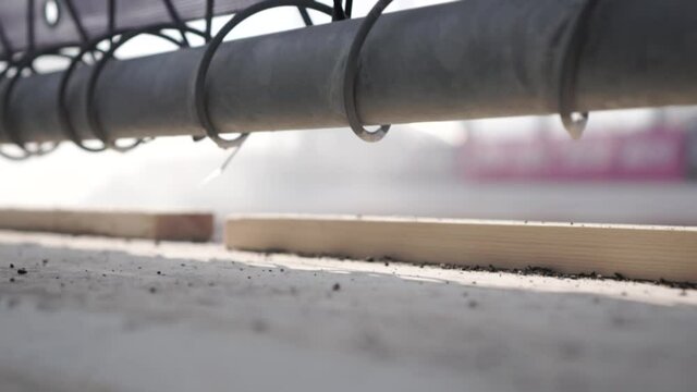 A close-up of a metal mesh fence on an automotive professional race track. Footage. View from behind the bars on the drifting car. The concept of restricting freedom and inability to watch the show