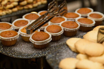 Buffet table with various cookies and biscuits, tarts and cakes