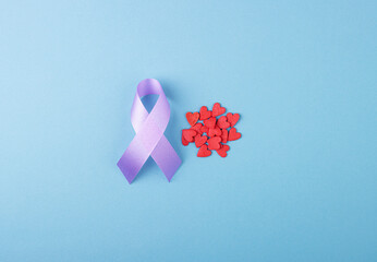 Purple ribbon with small red hearts, Epilepsy Day. Symbol of support for people living with cancer