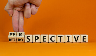 Perspective or retrospective symbol. Businessman hand turns cubes and changes word 'retrospective' to 'perspective'. Beautiful white background. Business and perspective concept. Copy space. - obrazy, fototapety, plakaty