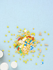 Vertical image of many multi-colored tablets, capsules and pills