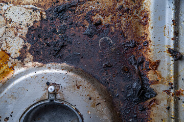unclean gas stove, steel kitchen cooktop, old fat stains, fry spots, oil splatters and burned-on...